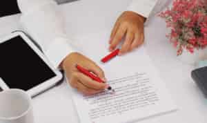 woman proofreading and highlighting document