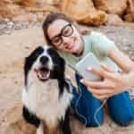 girl taking a selfie with her dog