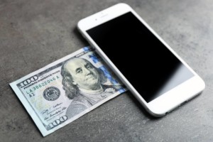 smartphone and 100 dollar bill