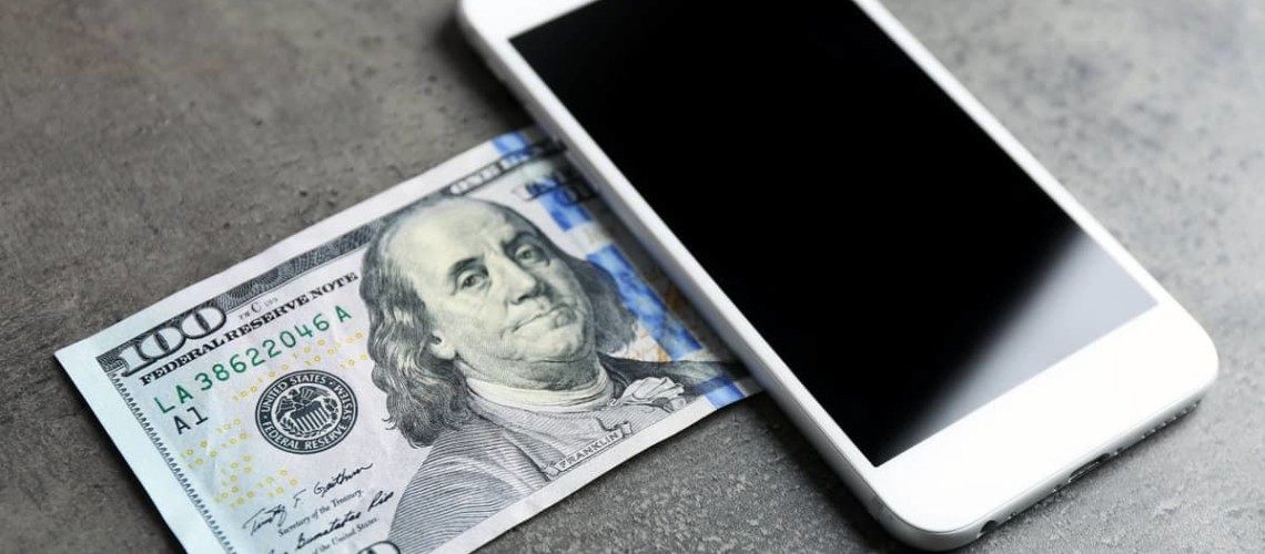 smartphone and 100 dollar bill