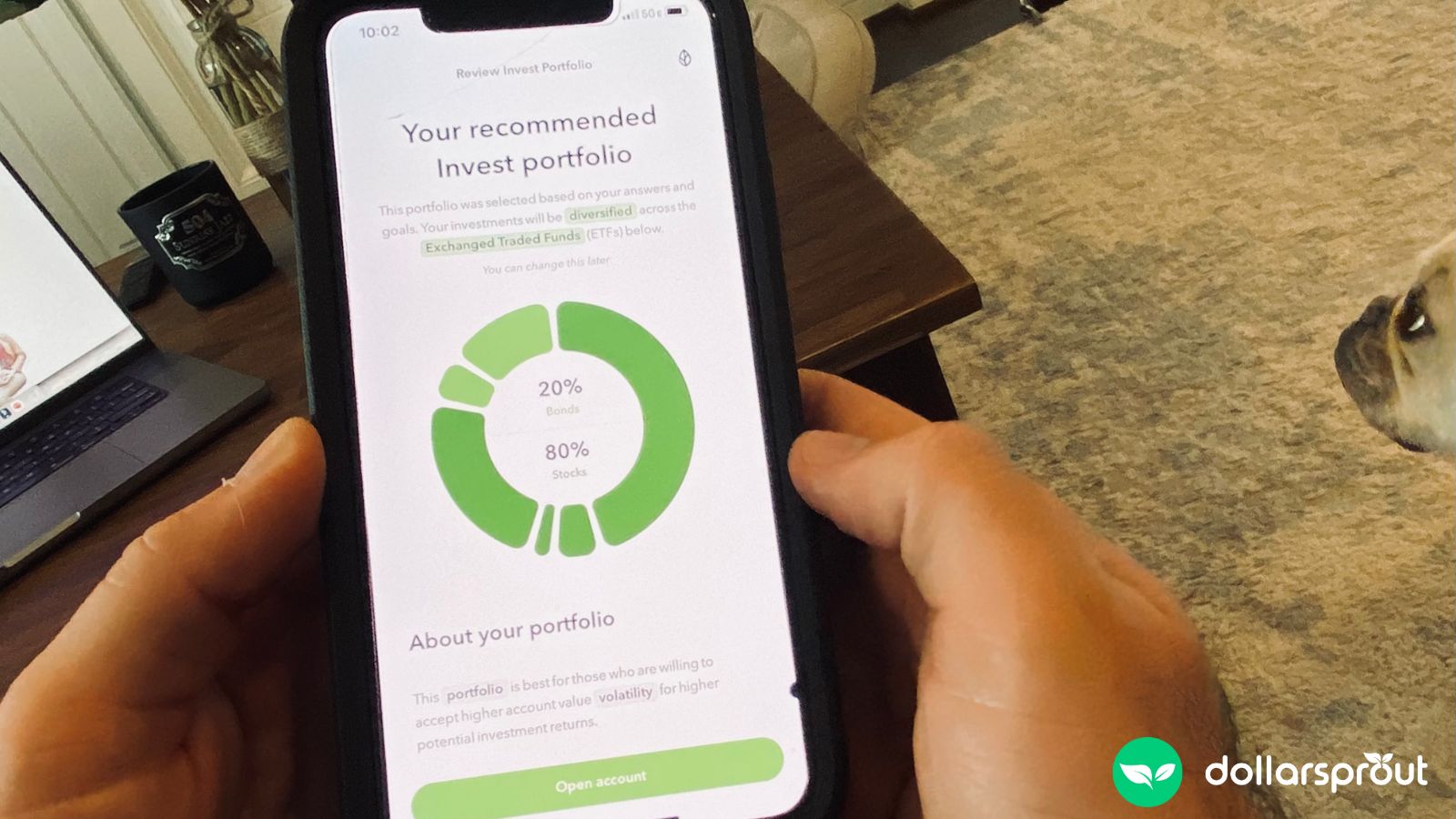 Photo showing me holding my phone with a screenshot from the Acorns app with a recommended portfolio.