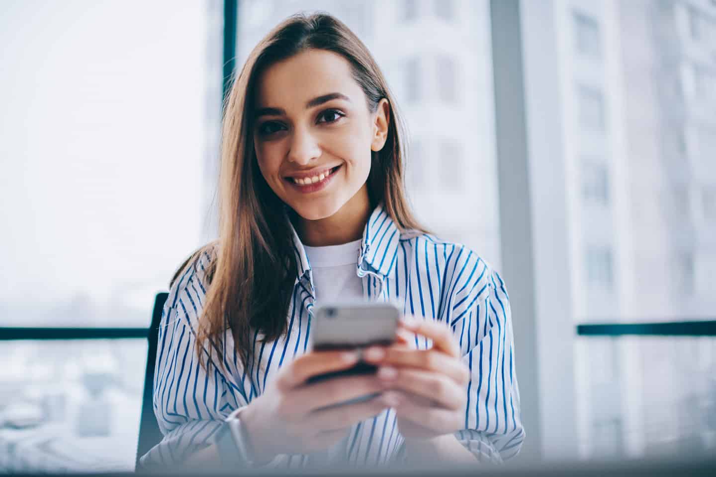 woman working from home on her smartphone