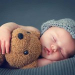 baby hugging a teddy bear