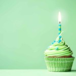 green cupcake with candle burning