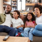 family sitting on couch watching free cable tv