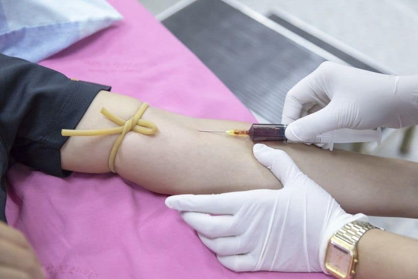 nurse drawing blood from patient