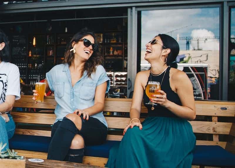 happy friends sitting together laughing