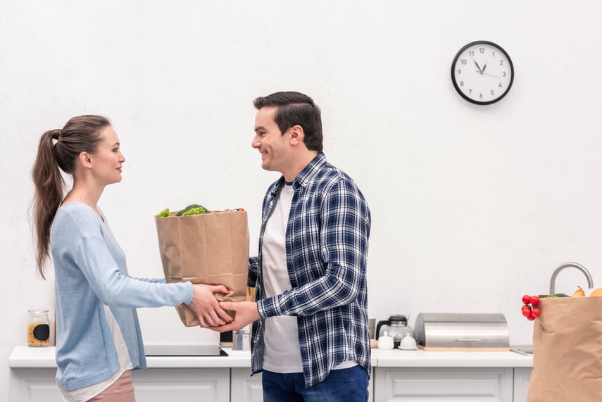 woman handing bag of food to man