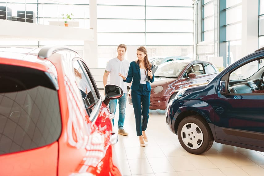 Man shopping for a new car. Here are some money saving tips when car shopping