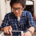 teenage boy doing work on iPad