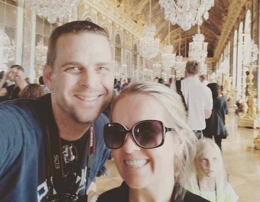 Holly and Greg Johnson in the Hall of Mirrors at Versailles, a symbol of the financial freedom they gained through freelance writing.