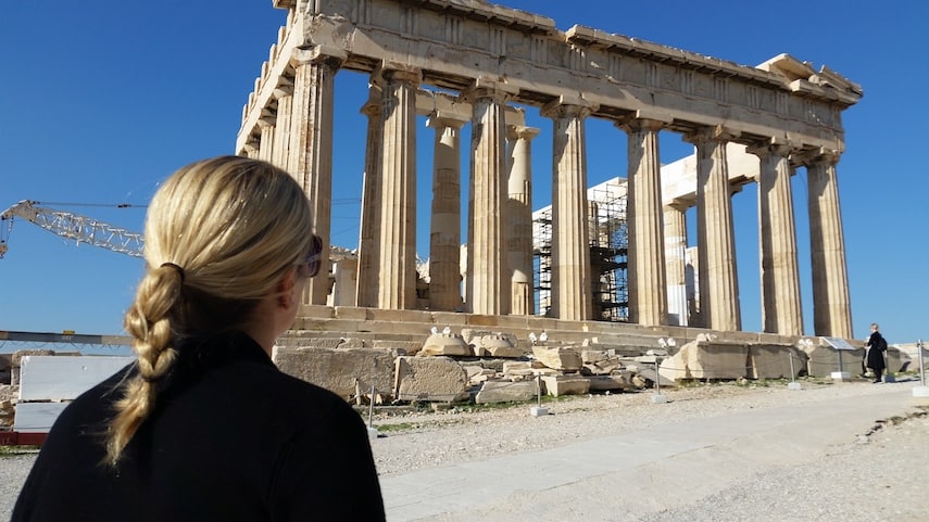 Holly Johnson at the Parthenon, enjoying the travel freedom her writing career provides.