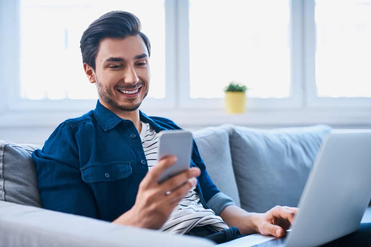 Internet calling. Men sitting with smartphone. Man with Phone Home. Sofa men Phone. Man with Phone Sofa.