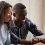 couple reading Dave Ramsey's 7 Baby Steps