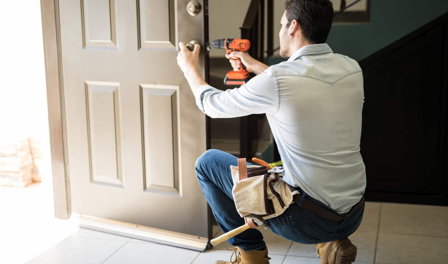 handyman fixing door knob