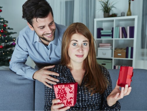 woman opening a box with a concerned face