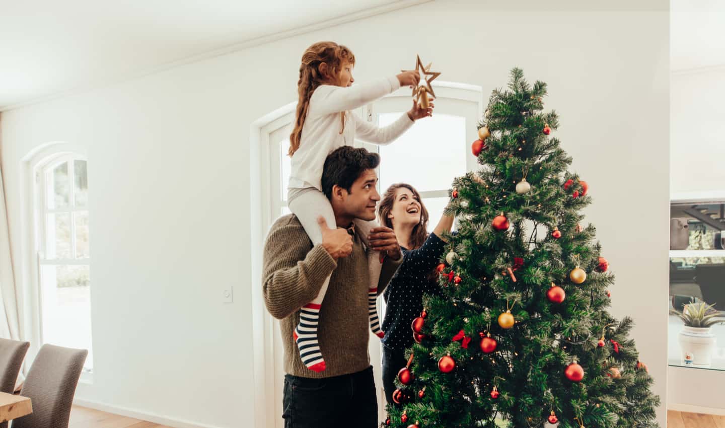 family decorating Christmas tree