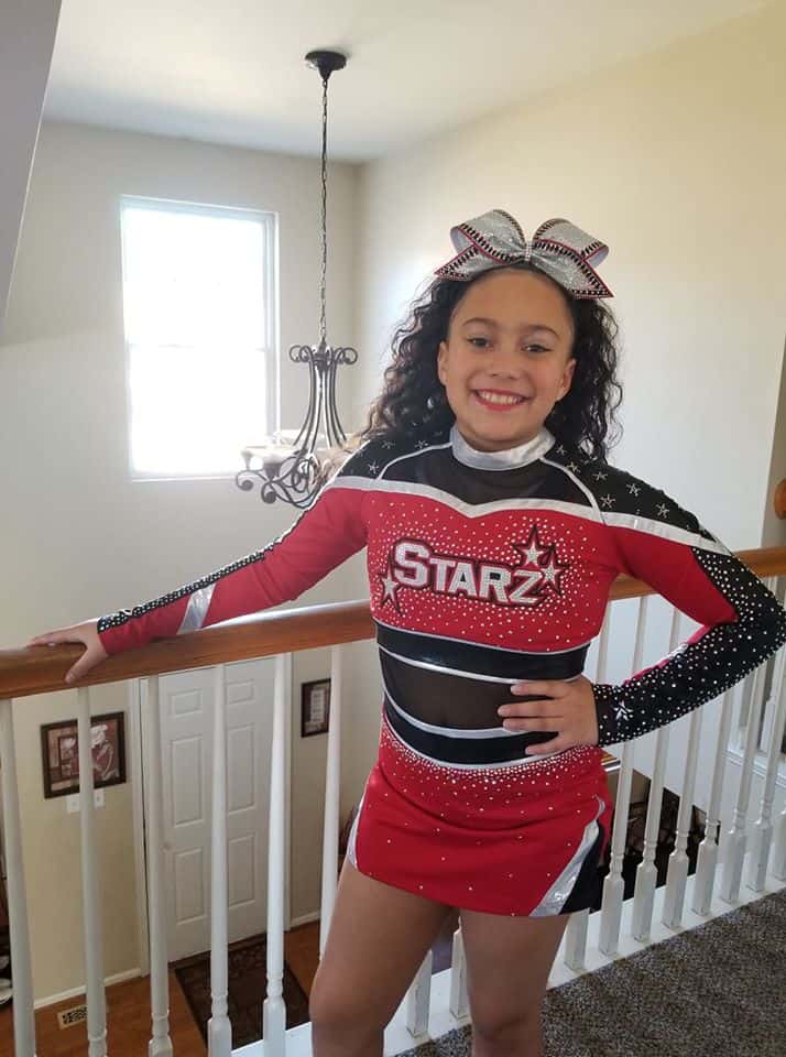 cheerleader posing by staircase