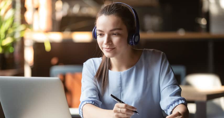 woman editing podcast on her laptop fizkes