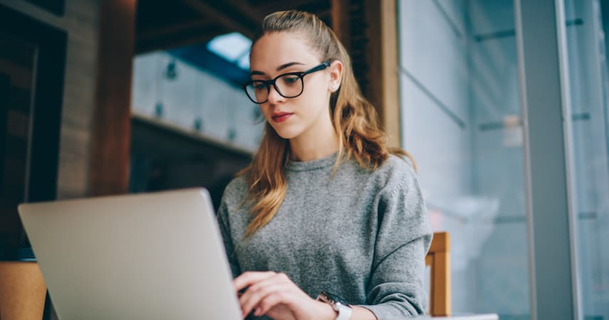 young woman building websites on her laptop GaudiLab