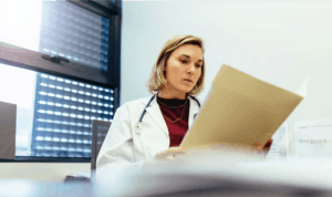 A female physician reading a chart