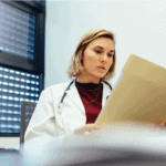 A female physician reading a chart