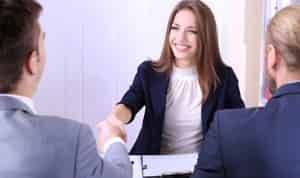 woman shaking hands at job interview