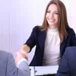 woman shaking hands at job interview