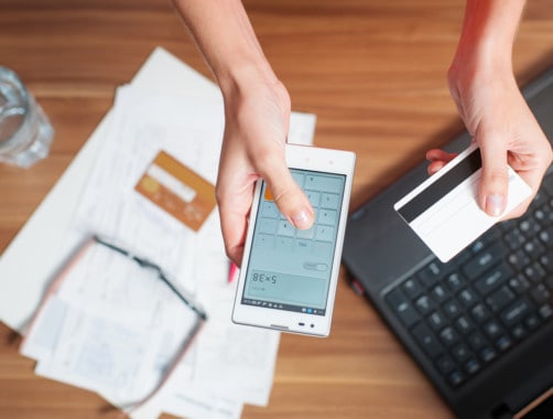 woman calculating savings on smartphone