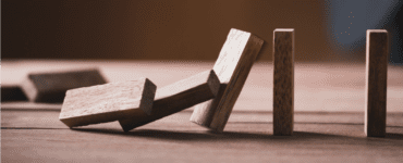 Jenga pieces falling like dominos as an illustration of risk