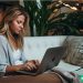 A freelancer working from her couch during quarantine.