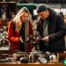 couple looking for items at a flea market to flip for a profit