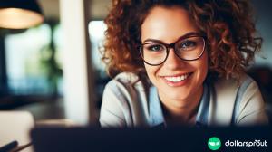 A close up shot of a woman wearing glasses in front of a laptop. She is working testing a new website.