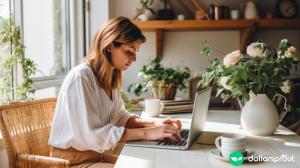 A woman sitting at her laptop about to start working on her blog.