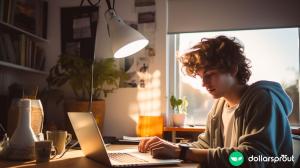 A teenage boy working on his laptop in his bedroom.