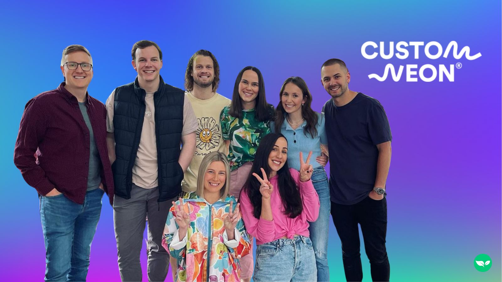 Jess and Jake standing with part of the Custom Neon team