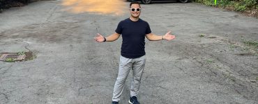 Justin Cambra posing in his vacant lot that he listed on Neighbor.com