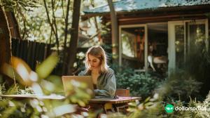 A woman working on her laptop outside