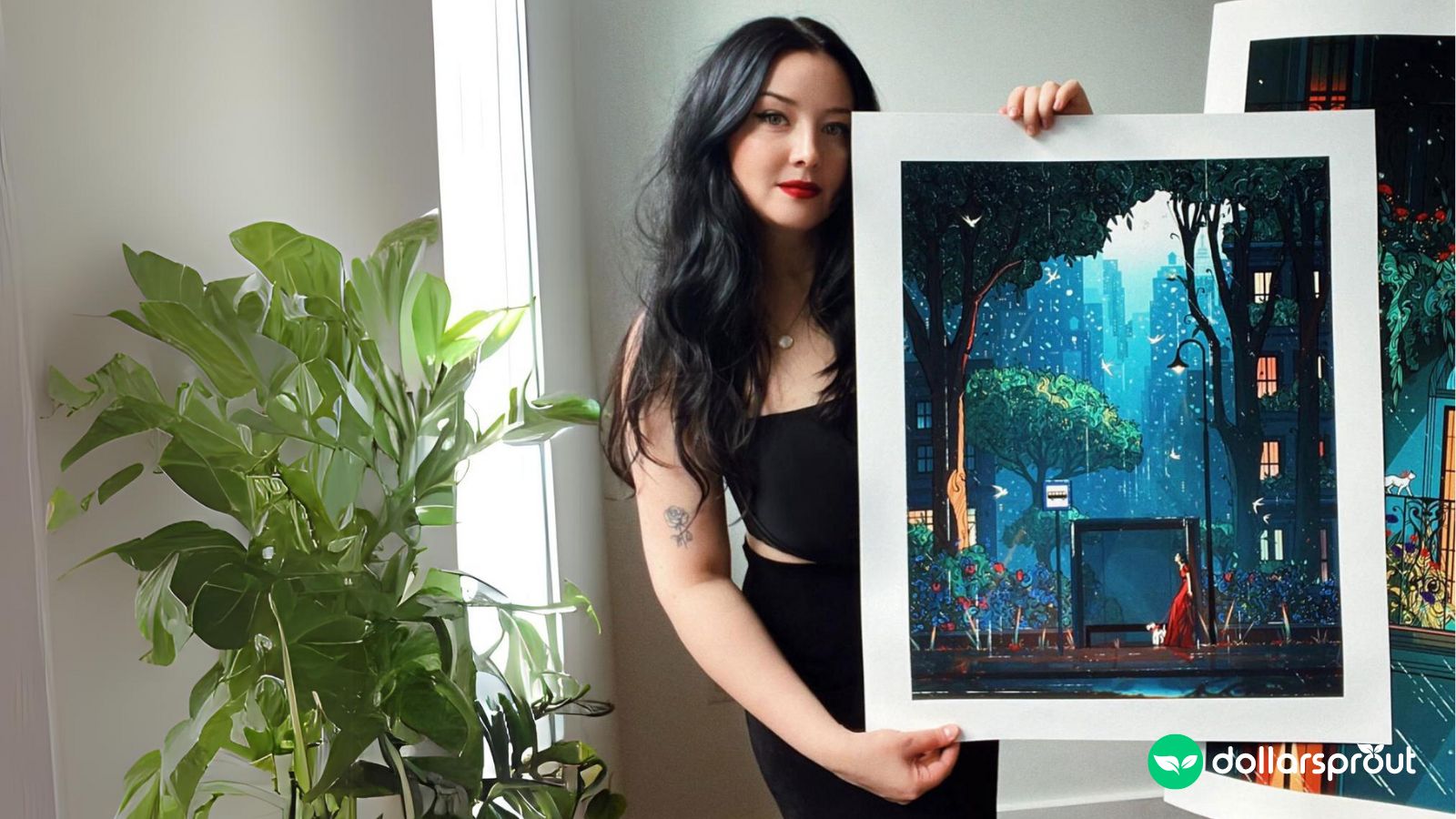 A photo of Laura El posing with one of her prints.