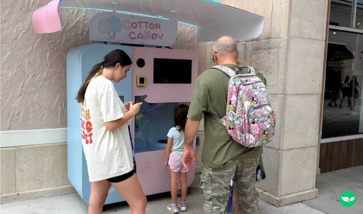 family standing at one of zach's cotton candy vending machines