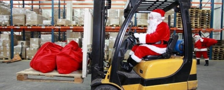 Man dressed as Santa driving a forklift