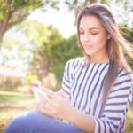 woman using her smartphone to earn free gift cards